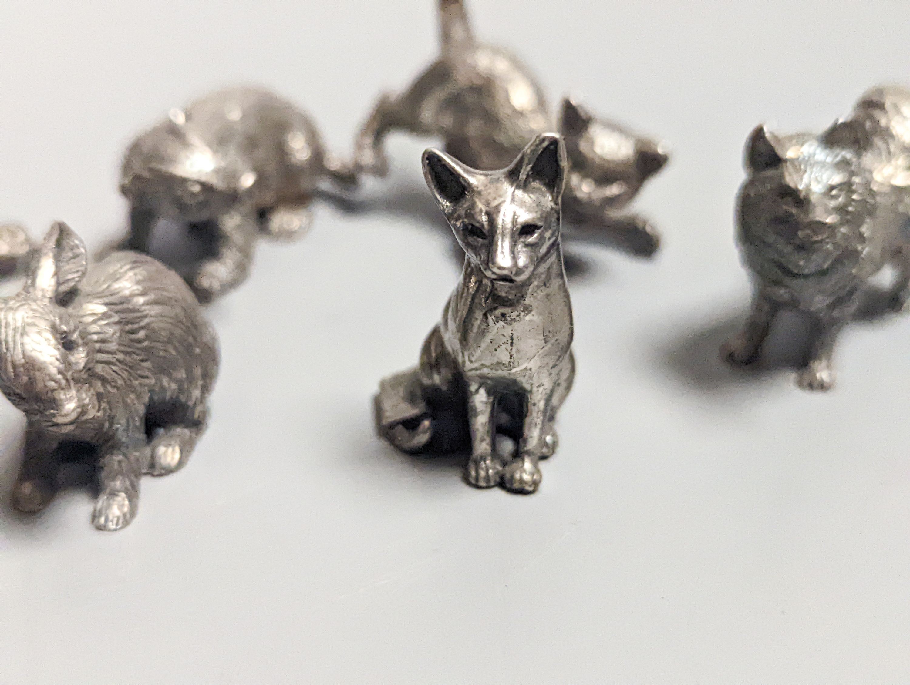 Four modern miniature freestanding model animals, including, badger, two dogs and a cat, JJSM, London, 1989 &1991, cat length 37mm, two Italian 925 models and two base metal models.